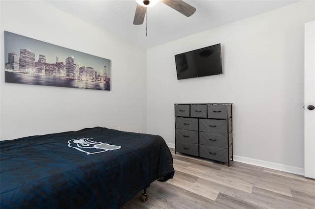 bedroom with hardwood / wood-style floors and ceiling fan