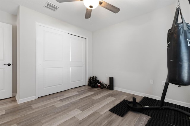 bedroom featuring light hardwood / wood-style flooring, ceiling fan, and a closet