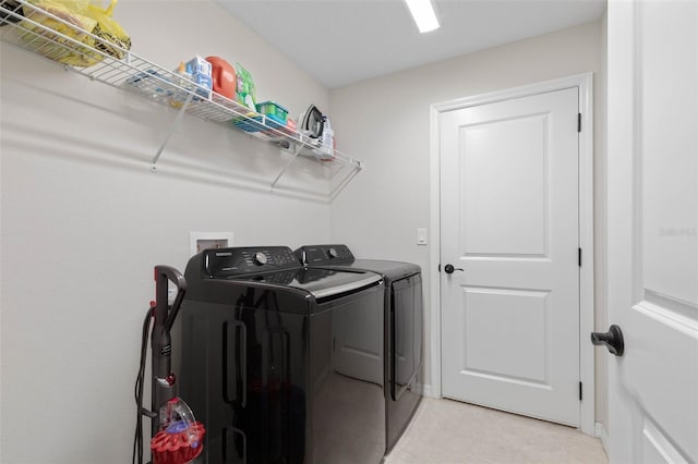 clothes washing area featuring washing machine and dryer