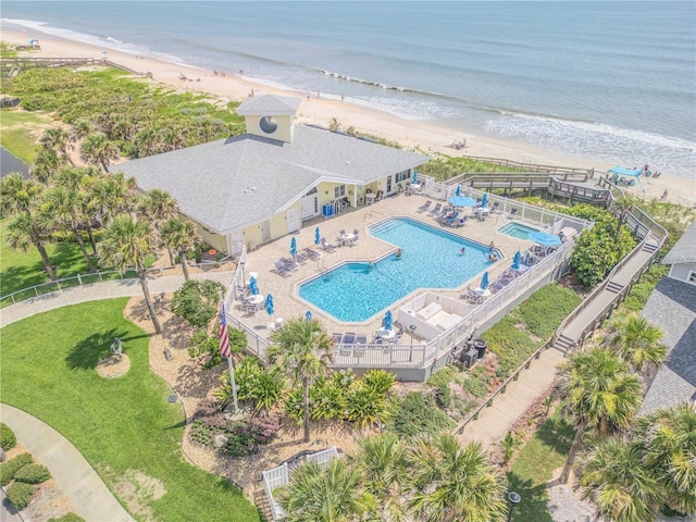 drone / aerial view with a water view and a beach view