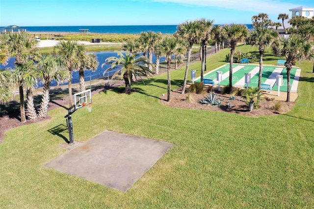 view of property's community featuring a water view and a yard