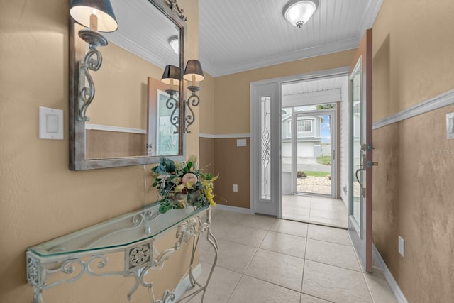 foyer entrance featuring ornamental molding and light tile patterned floors