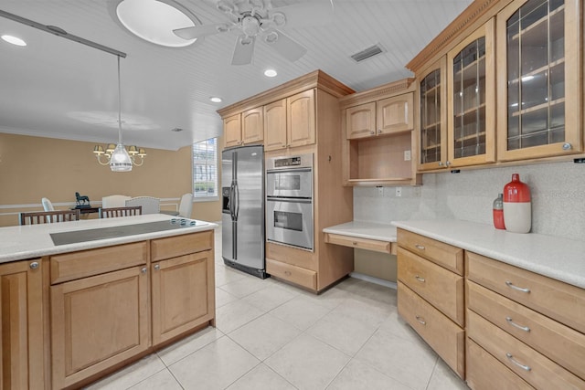 kitchen featuring decorative backsplash, ornamental molding, ceiling fan with notable chandelier, decorative light fixtures, and stainless steel appliances