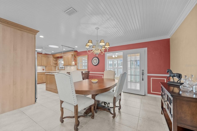 tiled dining space with ornamental molding and a notable chandelier