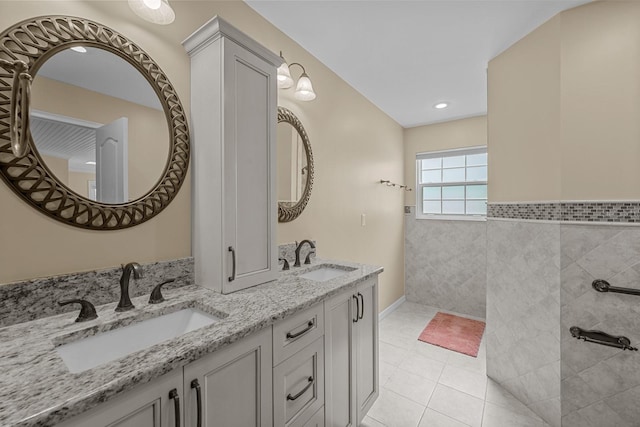 bathroom featuring vanity, tile patterned floors, and tile walls