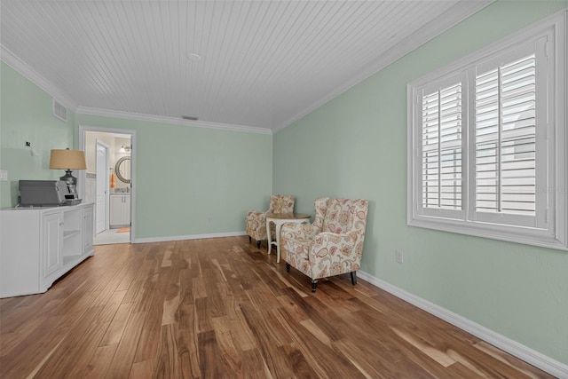 living area featuring ornamental molding, hardwood / wood-style flooring, and wooden ceiling