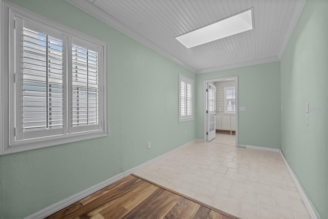 spare room featuring crown molding, wooden ceiling, and light wood-type flooring