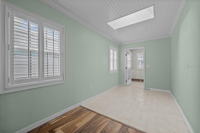 53 Sea Vista Dr, Palm Coast, FL 32137 - empty room with a skylight, ornamental molding, and baseboards