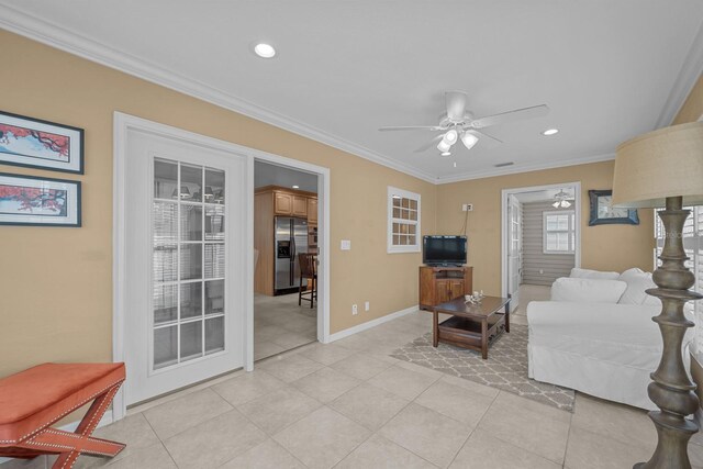 tiled living room featuring crown molding and ceiling fan