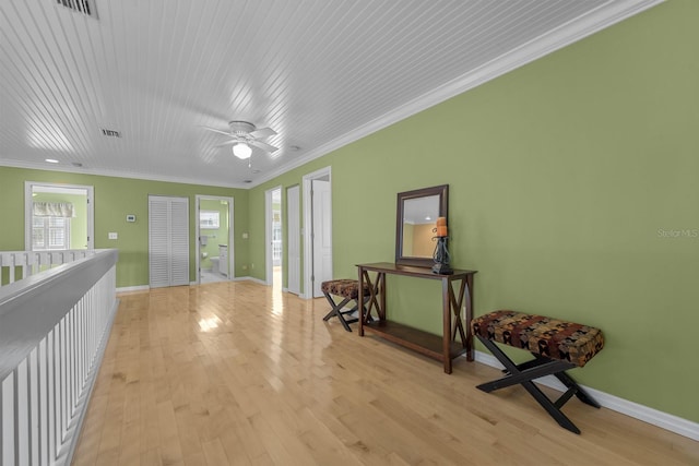 interior space featuring wooden ceiling, crown molding, light hardwood / wood-style floors, and ceiling fan