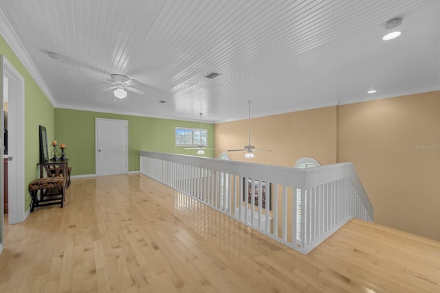 hallway featuring ornamental molding and light hardwood / wood-style flooring