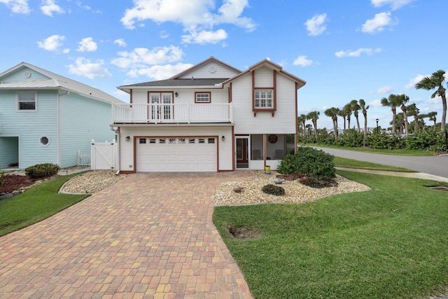 53 Sea Vista Dr, Palm Coast, FL 32137 - view of front facade with decorative driveway, a front yard, a balcony, and a gate
