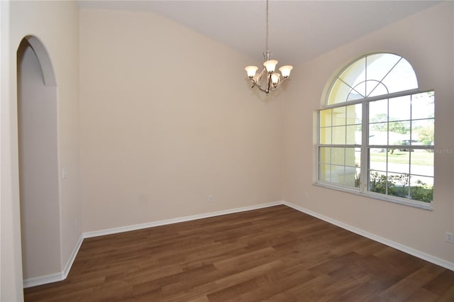 empty room with lofted ceiling, an inviting chandelier, and dark hardwood / wood-style flooring