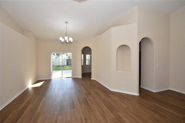 empty room featuring dark hardwood / wood-style floors and a chandelier