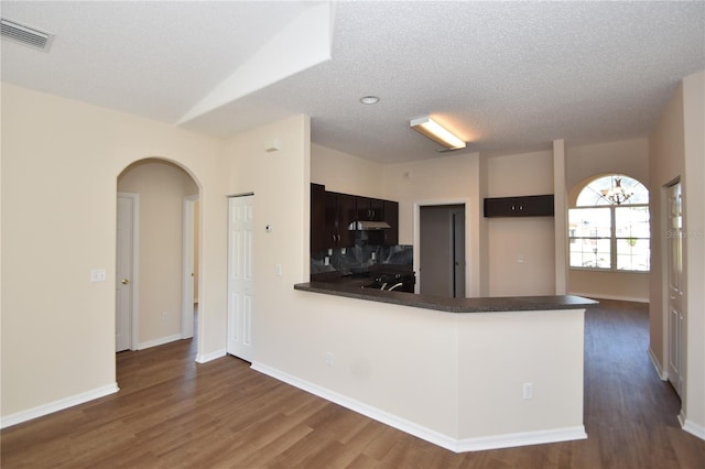 kitchen featuring dark hardwood / wood-style floors and kitchen peninsula