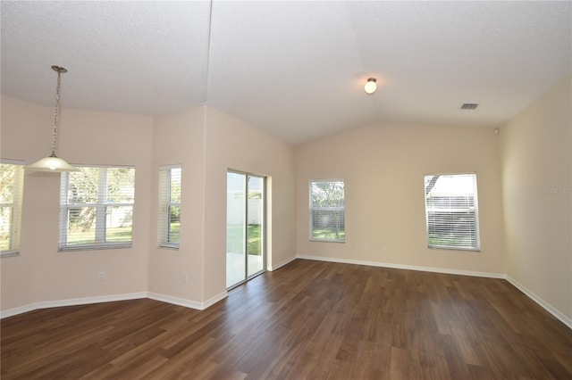 empty room featuring dark hardwood / wood-style floors and vaulted ceiling