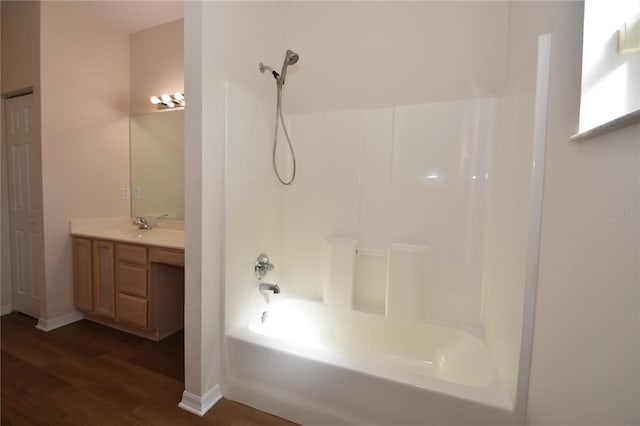 bathroom with vanity, hardwood / wood-style flooring, and tub / shower combination