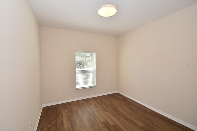 spare room with dark hardwood / wood-style flooring