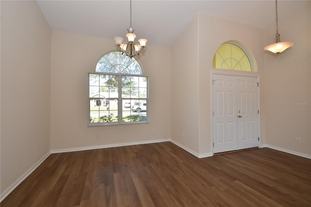 foyer entrance featuring a chandelier and dark hardwood / wood-style flooring