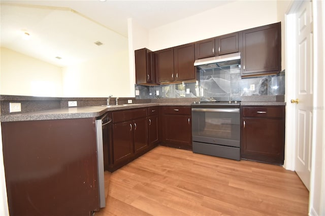 kitchen with appliances with stainless steel finishes, tasteful backsplash, lofted ceiling, sink, and light wood-type flooring