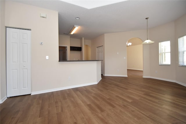 unfurnished living room featuring dark wood-type flooring