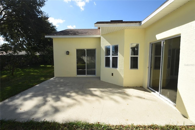 rear view of house with a yard and a patio area