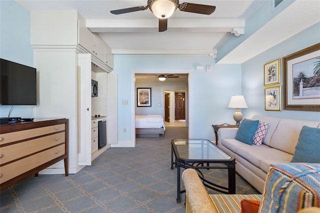 carpeted living room featuring ornamental molding, a textured ceiling, beam ceiling, and ceiling fan