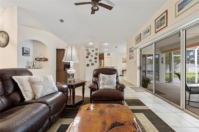 living room with ceiling fan, vaulted ceiling, and light tile patterned flooring