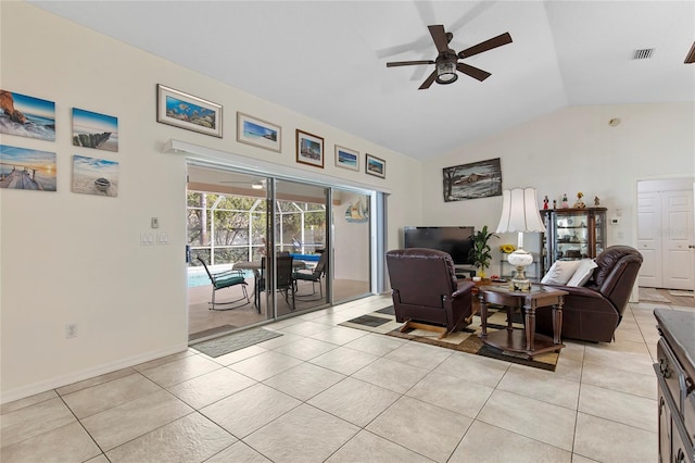 tiled living room with ceiling fan and vaulted ceiling