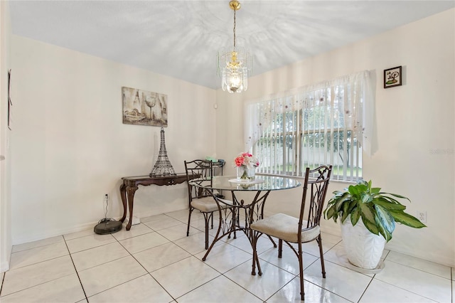 tiled dining room with a notable chandelier