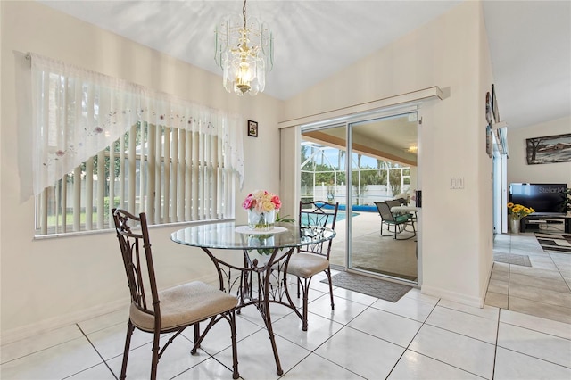 dining area featuring light tile patterned floors, an inviting chandelier, and vaulted ceiling