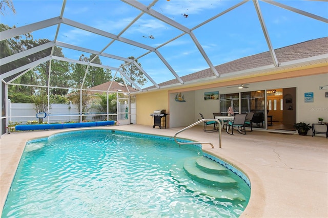 view of swimming pool with a patio area, a lanai, and ceiling fan