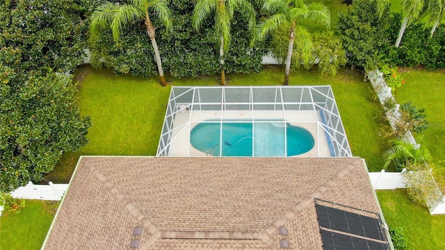 view of swimming pool featuring glass enclosure and a patio area