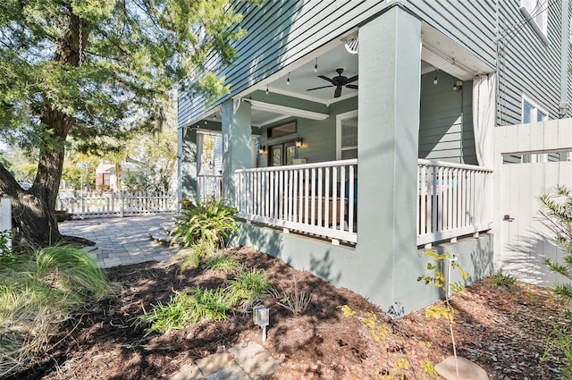 view of side of property with covered porch and ceiling fan