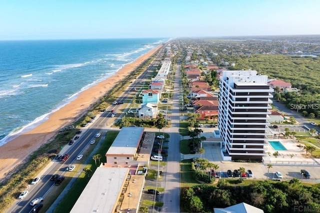 drone / aerial view with a water view and a beach view