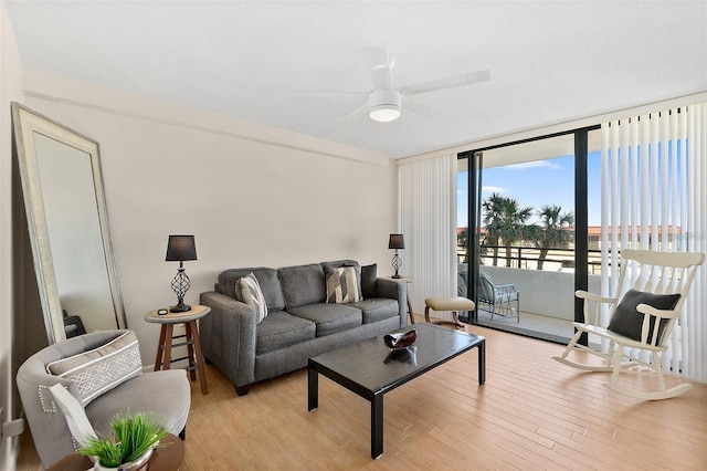 living room featuring light wood-type flooring and ceiling fan