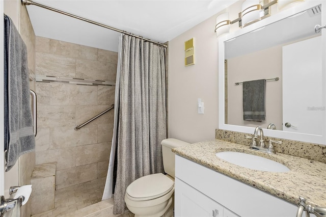 bathroom featuring toilet, vanity, a shower with shower curtain, and tile patterned flooring