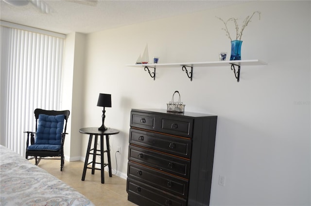 bedroom with a textured ceiling and ceiling fan