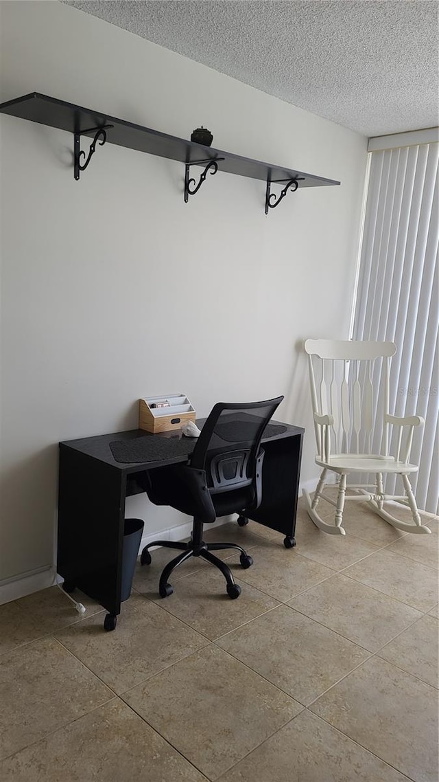 home office featuring a textured ceiling and light tile patterned floors