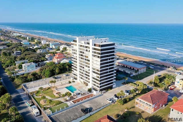 drone / aerial view with a water view and a view of the beach