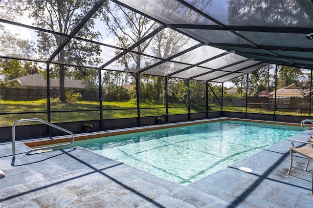 view of swimming pool with a patio area and a lanai