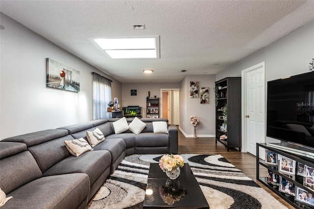 living room with dark wood-type flooring and a textured ceiling