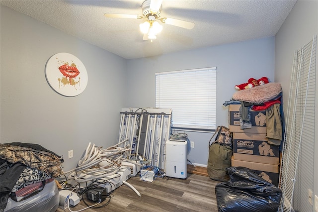 interior space featuring hardwood / wood-style floors, a textured ceiling, and ceiling fan