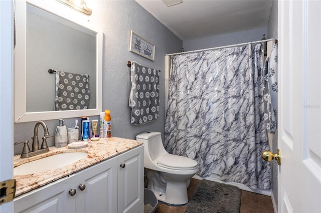 bathroom with toilet, walk in shower, vanity, and tile patterned floors