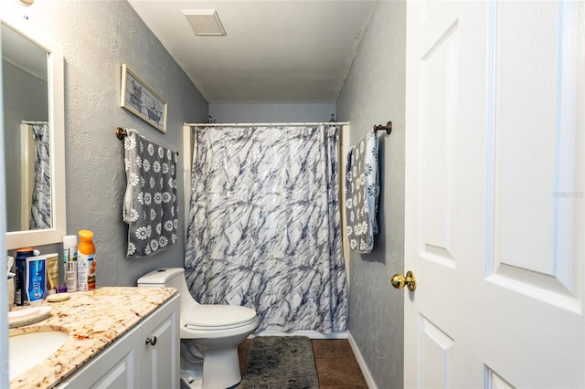 bathroom featuring toilet, a shower with curtain, vanity, and tile patterned flooring