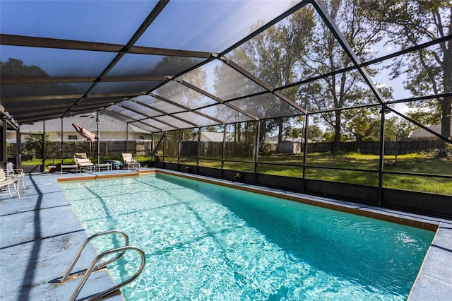 view of swimming pool with a patio area, a lanai, and a lawn