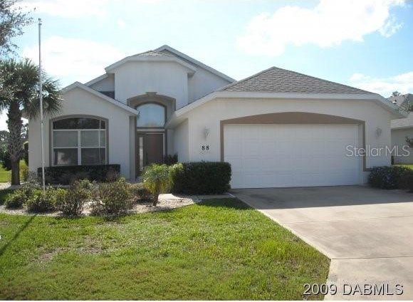 ranch-style house with a front lawn and a garage