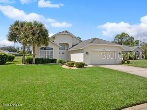 view of front facade with a garage and a front lawn