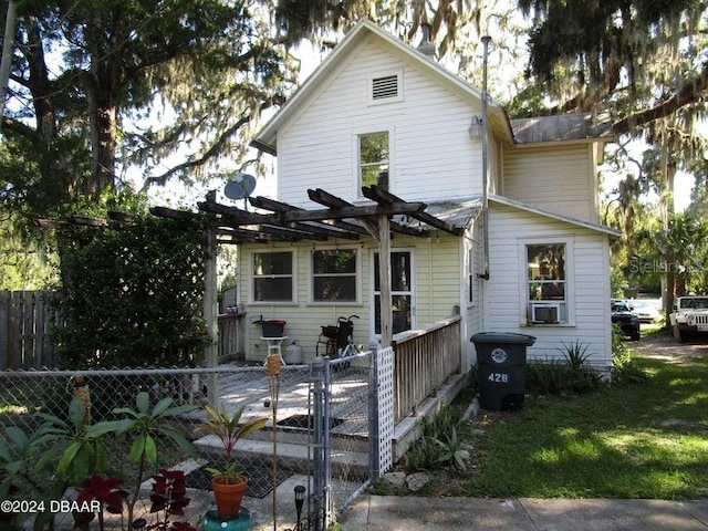 exterior space with cooling unit and a pergola