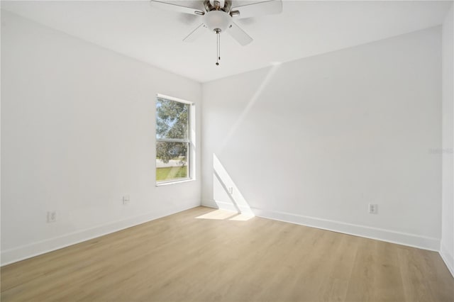 empty room featuring light wood-type flooring and ceiling fan